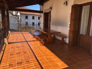 a wooden table and bench on a patio at Martintzenea in Sumbilla +17 photos