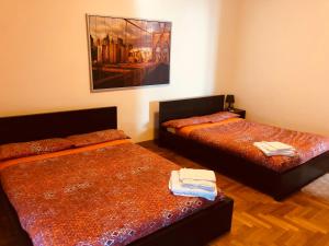a room with two beds and a painting on the wall at Ca’Melia B&B in Arconate