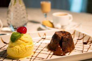 a plate with chocolate cake and ice cream on a table at Coral Plaza Apart Hotel in Natal