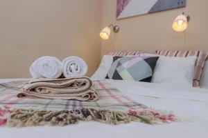 a bed with towels and pillows on top of it at Old Town Studio Apartment in Prague