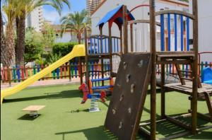 an outdoor playground with a slide and a slideintend at RINCONADA REAL BUNGALOW-PLAYA LEVANTE in Benidorm