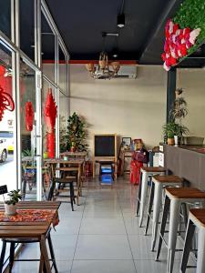 a restaurant with tables and chairs and a television at Casa Casa in Semporna +86 photos