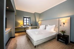 Ein Bett oder Betten in einem Zimmer der Unterkunft Hôtel Métropole Genève
