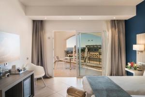a hotel room with a bed and a balcony at Royal Palm Resort & Spa - Adults Only in Playa Jandia