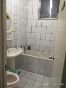 a bathroom with a bath tub and a sink at Art Taiwan Homestay in Shunan