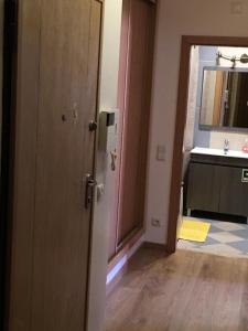 a bathroom with a sink and a door leading into a room at Ria Apartments in Olhão