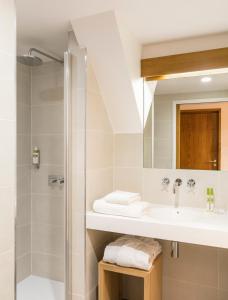 a bathroom with a sink and a shower at Abbaye de Royaumont in Viarmes