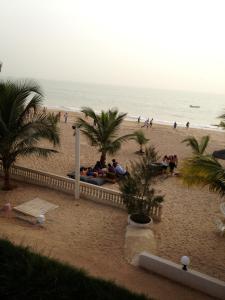 a group of people sitting on a beach at appartementsurlaplage in Saly Portudal