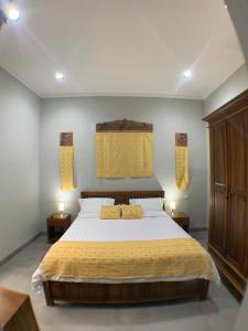 a bedroom with a large bed with two night stands at Dalai Home in Kuta Lombok