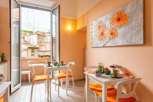 a room with two tables and chairs and a window at Merulana Suite 2 in Rome