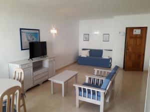 a living room with a tv and a couch at Dunas do Alvor apartment 146 in Alvor