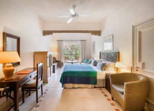 a bedroom with a bed and a table and chairs at Columbia Beach Resort in Pissouri