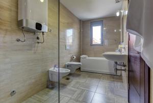 uma casa de banho com um WC, uma banheira e um lavatório. em Riva Residence em Herceg Novi