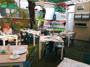 a restaurant with tables and chairs and people sitting at them at Meraki Boutique Hotel in Guatemala