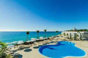 a resort with a swimming pool and the ocean at Royal Palm Resort & Spa - Adults Only in Playa Jandia