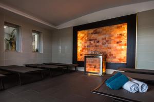a dining room with tables and a brick wall at Royal Palm Resort & Spa - Adults Only in Playa Jandia