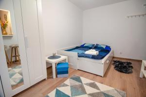 a small bedroom with a bed and a table at International Aparthotel in Cluj-Napoca