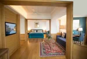 a living room with a couch and a bed at Columbia Beach Resort in Pissouri
