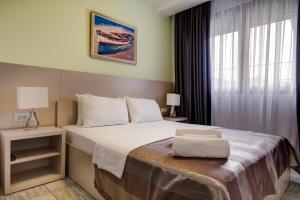 Postel nebo postele na pokoji v ubytování Riva Residence