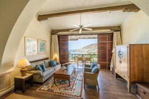 a living room with a couch and a table at Columbia Beach Resort in Pissouri