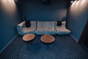 a blue couch in a room with two tables at Annas Hotel - Design Hotel Spa Restaurant in Annas