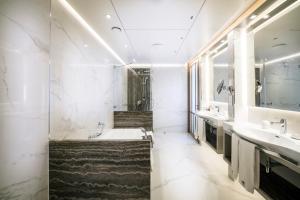 a bathroom with two sinks and a bath tub at Columbia Beach Resort in Pissouri