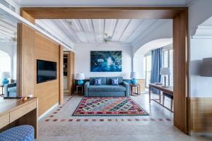 a living room with a couch and a tv at Columbia Beach Resort in Pissouri