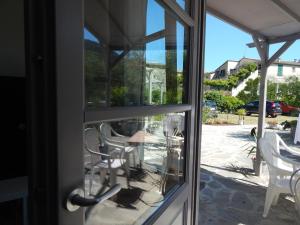 a view of a table and chairs through a window at B&B Piè del Castello in Levanto