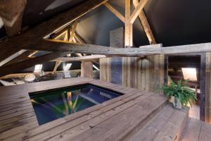 a wooden deck with a swimming pool in a building at Abbaye de Talloires in Talloires