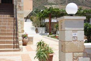 a stairway with potted plants and a building at Romantica Apartments in Falasarna