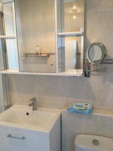 a bathroom with a sink and a mirror and a toilet at Both Worlds Sandy Bay in Gibraltar +21 photos