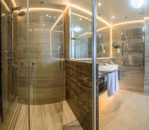 a bathroom with a shower and a sink at Columbia Beach Resort in Pissouri