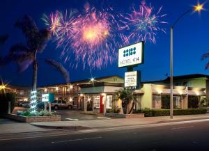 a firework display in the sky above a store at Hotel 414 Anaheim in Anaheim