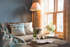 a living room with a couch with a table with wine glasses at Gothic Eves Inn and Spa Bed and Breakfast in Trumansburg