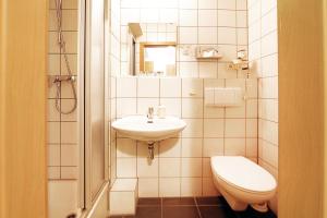 a small bathroom with a sink and a toilet at bp24 Hotel Aachen in Aachen