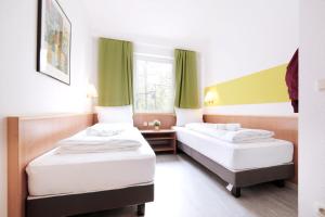 Letto o letti in una camera di bp24 Hotel Aachen