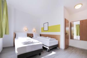 Letto o letti in una camera di bp24 Hotel Aachen