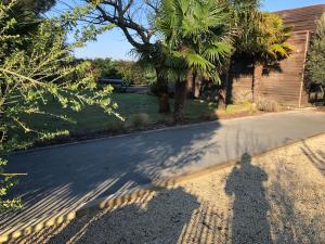 a shadow of a person walking down a street at Cap Ferret Villa Océane in Lège-Cap-Ferret +40 photos