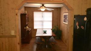 a dining room with a table and a window at The Sandstone - A 3BR, 2BA Deluxe Log Cabin in Genoa