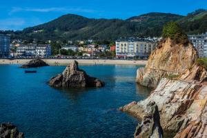 a view of a beach with rocks in the water at Apartamento Playa de Covas in Viveiro