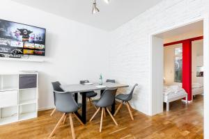 a dining room with a table and four chairs at DR APARTMENTS in Berlin