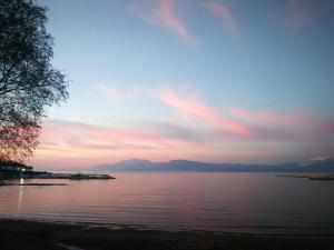 a large body of water with a sunset in the background at Explore Greece from Near the Sea Apartment in Chalkida