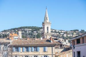 a view of a city with a church tower at Hôtel Provence in Draguignan