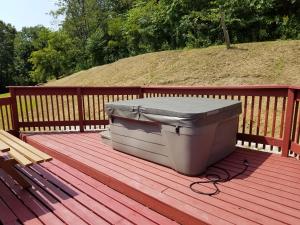 a cooler sitting on top of a wooden deck at The Sandstone - A 3BR, 2BA Deluxe Log Cabin in Genoa