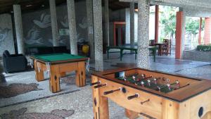 a room with a pool table and a table sidx sidx at Chalé 01 em Maragogi Brasil Maragogi in Maragogi