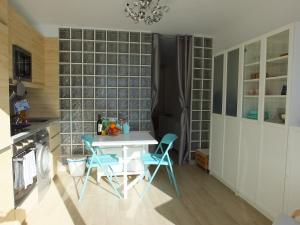 a kitchen with a table and chairs in a room at BLU in Puerto del Carmen