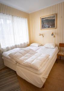 Säng eller sängar i ett rum på Enaforsholm Fjällgård