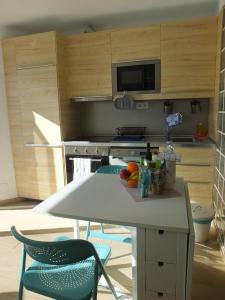 a kitchen with a table and two chairs and a stove at BLU in Puerto del Carmen