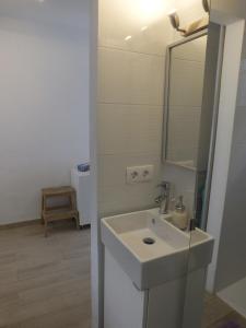 a white bathroom with a sink and a mirror at BLU in Puerto del Carmen +21 photos