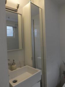 a white bathroom with a sink and a shower at BLU in Puerto del Carmen